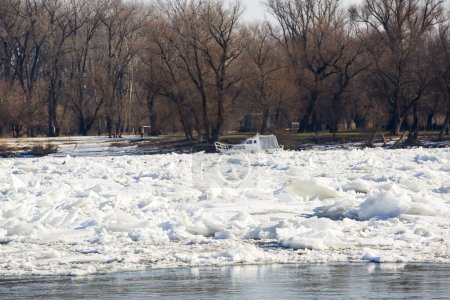 Photo for Boat trapped in ice on frozen river Danube - Royalty Free Image