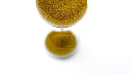 Foto de Reloj de arena con cuentas de oro sobre fondo blanco - Imagen libre de derechos