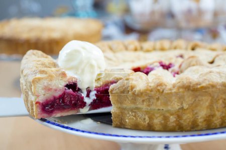 Photo for Homemade traditional sweet raspberry tart pie with ice cream on wooden table background. - Royalty Free Image