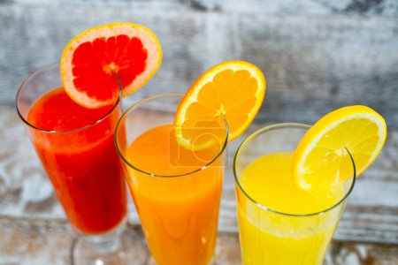 Photo for Freshly squeezed juices on wooden background - Royalty Free Image
