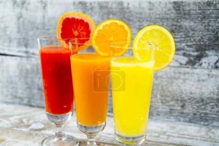 Photo for Freshly squeezed juices on wooden background - Royalty Free Image