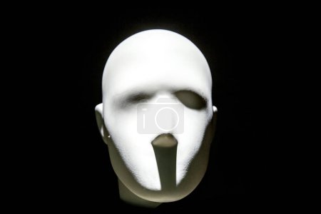 Photo for Mannequin face with moody lighting on dark background - Royalty Free Image
