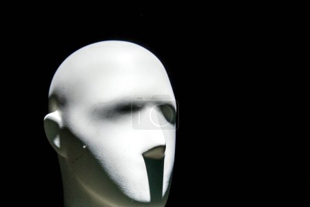 Photo for Mannequin face with moody lighting on dark background - Royalty Free Image
