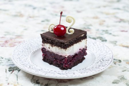 Photo for Chocolate cake with whipped cream and cherry on top - Royalty Free Image