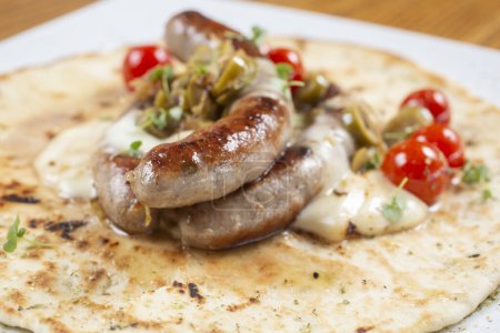 Photo for Grilled sausage in a tortilla with tomato and spices - Royalty Free Image