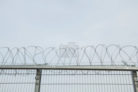 Photo for A razor wire on the border between two countries - Royalty Free Image