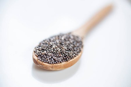 Photo for Chia seeds in wooden spoon on white background - Royalty Free Image
