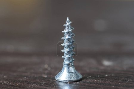 Photo for Screw isolated on wooden background - Royalty Free Image