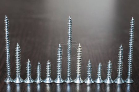 Photo for Screw set on wooden background - Royalty Free Image