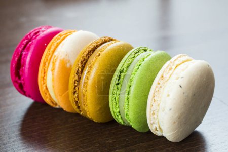 Photo for Colorful macarons on wooden table - Royalty Free Image
