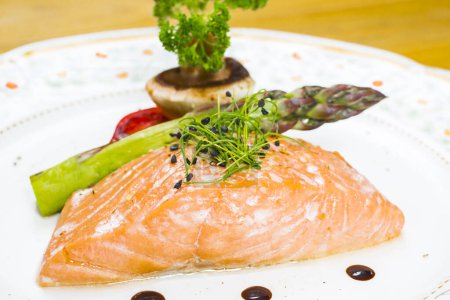 Photo for Salmon fillet with vegetables and a silver weight for recreation - Royalty Free Image
