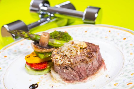 Photo for Steak with vegetables and weights for recreation - Royalty Free Image