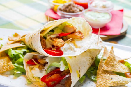 Photo for Mexican tortilla wrap with chicken breast and vegetables - Royalty Free Image