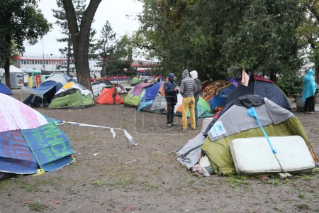 Photo for SERBIA, BELGRADE - September 01,2015: Park at the station migrants from Syria have turned into a small city. Some have even set up tents and in which they reside, while most sleep under the open sky. - Royalty Free Image