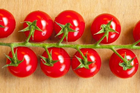 Photo for Fresh cherry tomatoes on the wooden background - Royalty Free Image