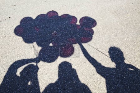 Photo for Shadows on pavement with balloons - Royalty Free Image