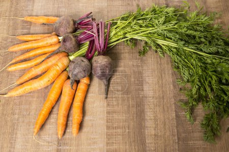 Photo for Fresh vegetables carrots, beetroots on wooden background. Harvest still life - Royalty Free Image