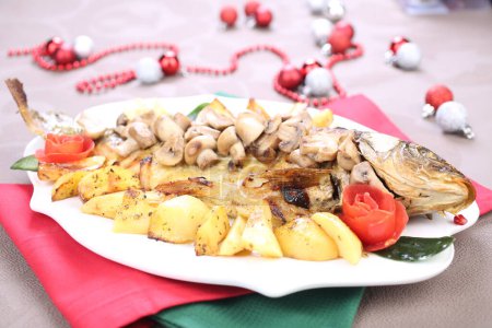 Photo for Roasted Carp fish with potatoes and mushrooms - Royalty Free Image