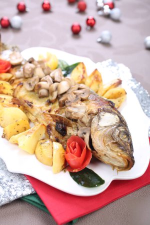 Photo for Roasted Carp fish with potatoes and mushrooms - Royalty Free Image