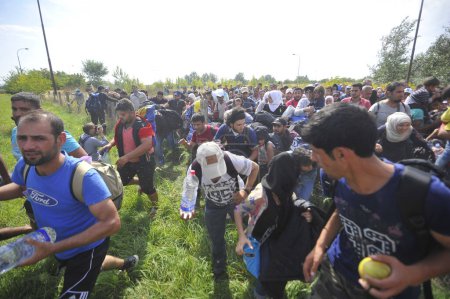 Photo for SERBIA-September 2015: Hungary closed its border with Serbia after the entry into force of the law for anyone who tries to illegally yarn. Migrants in the "no man's land" on the border crossing Horgos - Royalty Free Image