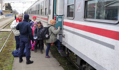 Photo for SID, SERBIA - FEBRUARY, 2016: Refugees boarding a train to the refugee camp of Sid, in Serbia. - Royalty Free Image