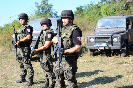 Foto de BELGRADE, SERBIA - CIRCA SEPTIEMBRE DE 2014: Oficiales de la unidad especial antiterrorista serbia en la frontera con Kosovo, alrededor de septiembre de 2014 en Serbia - Imagen libre de derechos