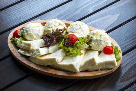 Photo for Cheese and cream on wooden plate - Royalty Free Image