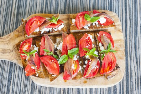 Téléchargez les photos : Crostini aux anchois, olives et tomates - en image libre de droit