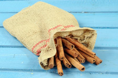 Photo for Cinnamon isolated on wooden background - Royalty Free Image