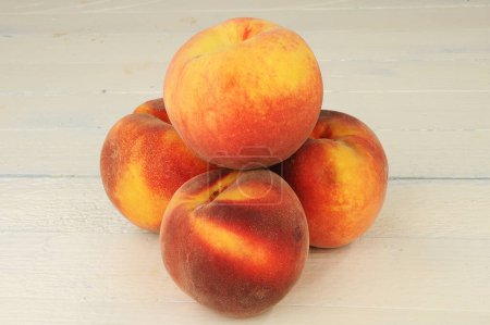 Photo for Peaches isolated on wooden background - Royalty Free Image