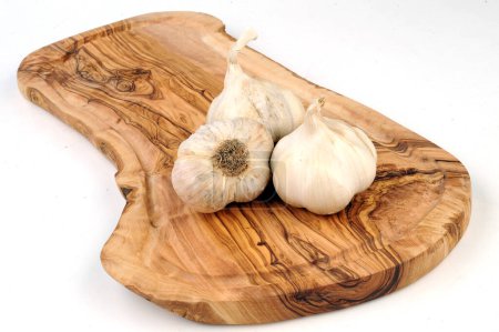 Photo for Garlic on a wooden olive plank - Royalty Free Image