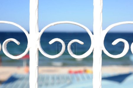 Photo for Decorative white railing on blurred sea beach background - Royalty Free Image