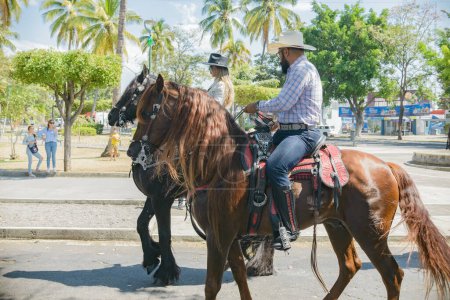 Photo for Villa de Alvarez, Colima, Mexico. February 11, 2023. Group of people on horseback in the horse parade for the charro bullfighting festivities in the city of Villa de Alvarez. - Royalty Free Image