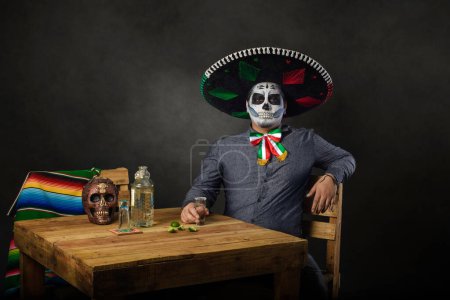 Photo for Catrin wearing mariachi hat and raising a toast in a bar. Day of the dead celebration. - Royalty Free Image
