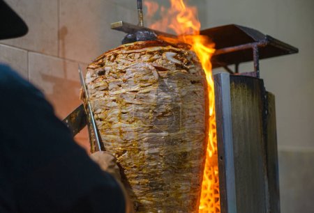 Meat trompo for tacos al pastor. Mexican street food. Marinated meat al pastor.