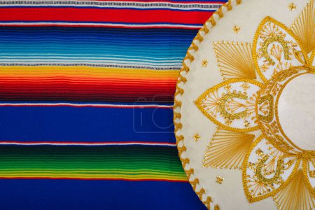 Photo for Mariachi hat on a colorful serape. Mexican sombrero. Typical charro hat. - Royalty Free Image