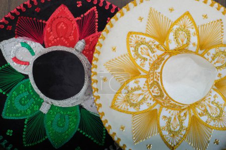Photo for Mexican charro hats on wooden table. Mariachi hats. Typical mexican sombreros. - Royalty Free Image