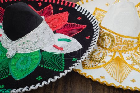 Photo for Mexican charro hats on wooden table. Mariachi hats. Typical mexican sombreros. - Royalty Free Image