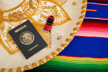 Photo for Mexican passport and mariachi hat on colorful serape. Concept of mexicanity. - Royalty Free Image