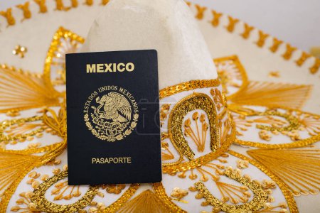 Photo for Mexican passport on charro hat. Mariachi hat and Mexican passport. Mexican citizenship concept. - Royalty Free Image