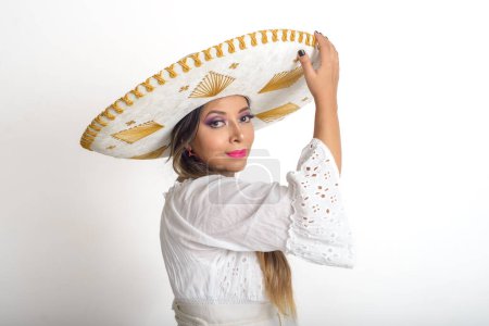 Photo for Mexican woman wearing a mariachi hat. Woman with sombrero, white background. - Royalty Free Image