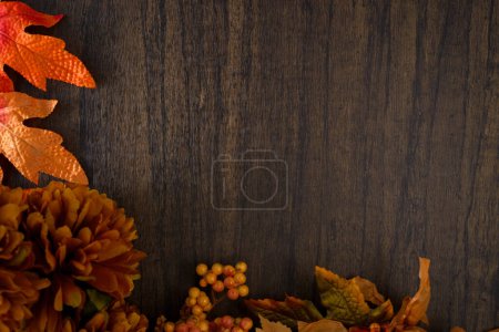 Photo for Leaves and flowers with autumn colors on wooden table. Autumn background. - Royalty Free Image