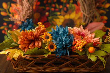 Photo for Wicker basket with autumn decorations on wooden table. - Royalty Free Image