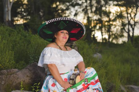 Photo for Woman with Mexican hat in rural scenery. Cinco de Mayo celebration in Mexico. - Royalty Free Image