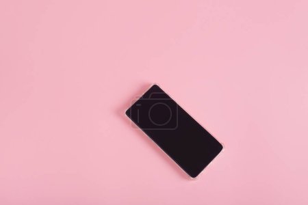 Cell phone isolated on pink background. Technology, mockup.