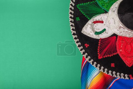 Photo for Mariachi hat and serape on green background. Mexican independence concept. Cinco de mayo background. - Royalty Free Image