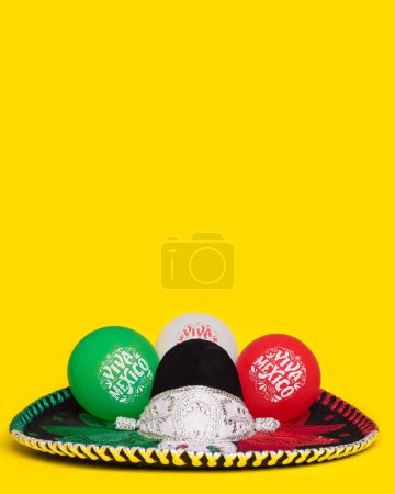 Photo for Mexican mariachi hat and balloons with text Viva Mexico, yellow background. Festive background; Cinco de Mayo, Mexican Independence Day. - Royalty Free Image