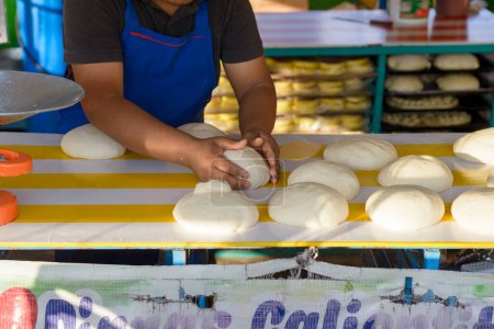 Bäcker bereitet Brot in einer Straßenbäckerei auf einem mexikanischen Markt zu.