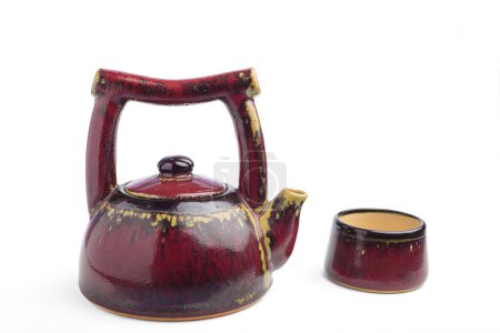 Teapot and teacup made of ceramic isolated on white background.