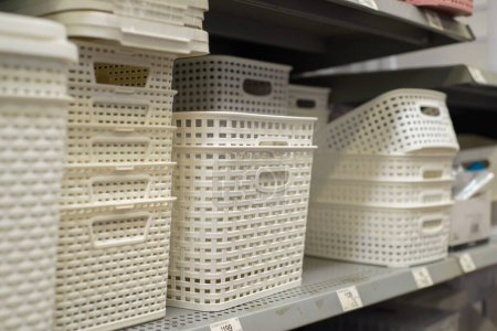 Plastic baskets on a supermarket shelf.